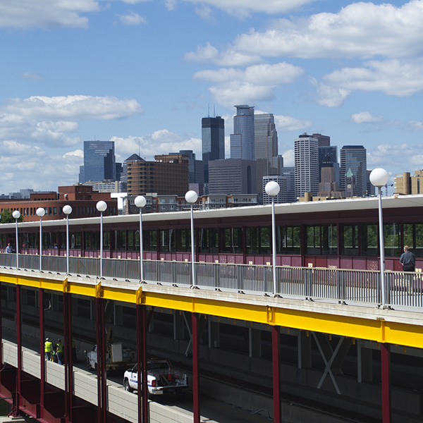 View of Washington Avenue Bridge in Minneapolis with downtown skyline in the background